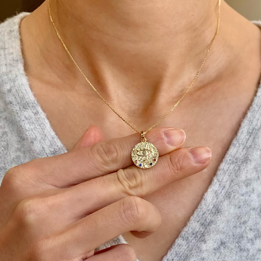 model wearing 14ct solid gold evil eye medallion pendant necklace